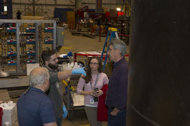 NASA image: TECHNICIANS AND ENGINEERS DISCUSS EPOXY POURING PROCESS