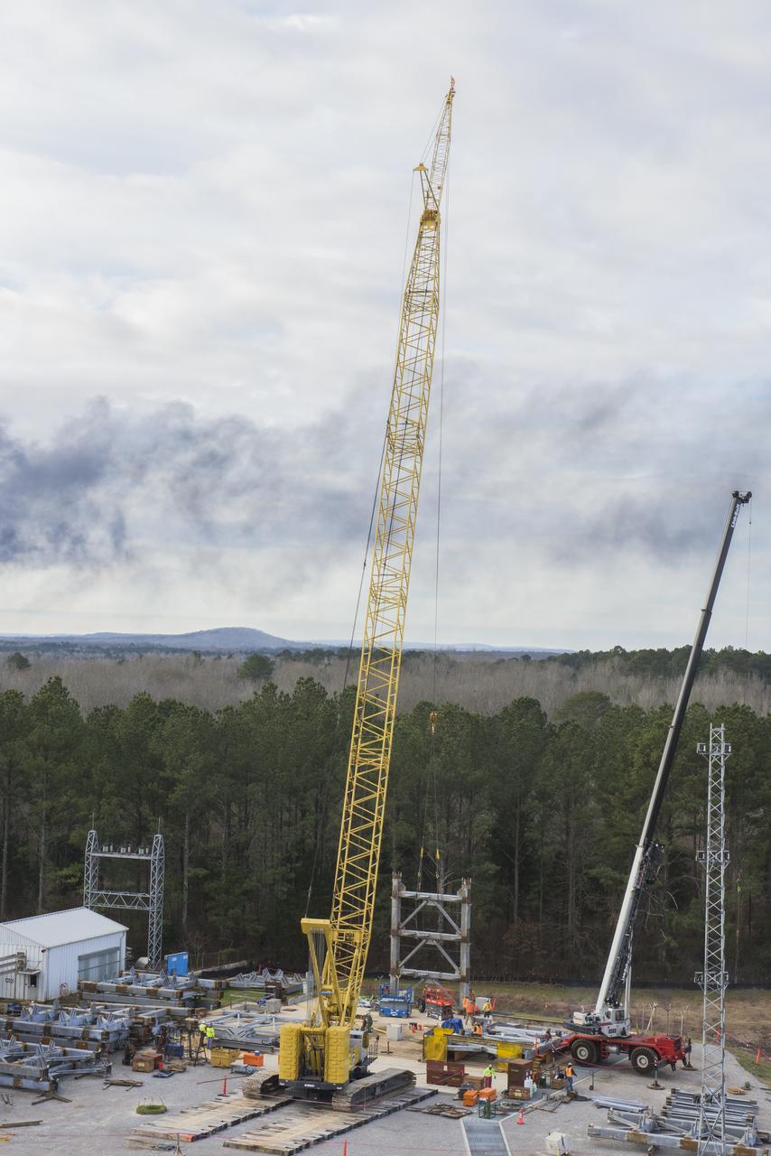 A CRANE MOVES THE FIRST STEEL TIER TO BE BOLTED INTO PLACE ON JAN. 6, FOR WELDING OF A SECOND NEW STRUCTURAL TEST STAND AT NASA'S MARSHALL SPACE FLIGHT CENTER IN HUNTSVILLE, ALABAMA -- CRITICAL TO DEVELOPMENT OF NASA'S SPACE LAUNCH SYSTEM. WHEN COMPLETED THIS SUMMER, THE 85-FOOT-TALL TEST STAND 4697 WILL USE HYDRAULIC CYLINDERS TO SUBJECT THE LIQUID OXYGEN TANK AND HARDWARE OF THE MASSIVE SLS CORE STAGE TO THE SAME LOADS AND STRESSES IT WILL ENDURE DURING A LAUNCH. THE STAND IS RISING IN MARSHALL'S WEST TEST AREA, WHERE WORK IS ALSO UNDERWAY ON THE 215-FOOT-TALL TOWERS OF TEST STAND 4693, WHICH WILL CONDUCT SIMILAR STRUCTURAL TESTS ON THE SLS CORE STAGE'S LIQUID HYDROGEN TANK. SLS, THE MOST POWERFUL ROCKET EVER BUILT, WILL CARRY ASTRONAUTS IN NASA'S ORION SPACECRAFT ON DEEP SPACE MISSIONS, INCLUDING THE JOURNEY TO MARS.