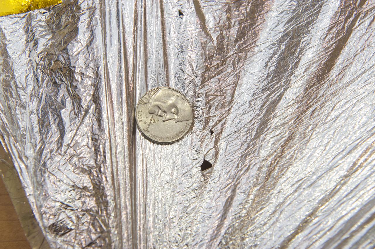 TIFFANY LOCKETT OVERSEES THE HALF SCALE (36 SQUARE METERS) ENGINEERING DEVELOPMENT UNIT (EDU) SOLAR SAIL DEPLOYMENT DEMONSTRATION IN PREPARATION FOR FULL SCALE EDU (86 SQUARE METERS) DEPLOYMENT IN APRIL, 2016. DETAILS OF RIPS AND HOLES IN SOLAR SAIL FABRIC.