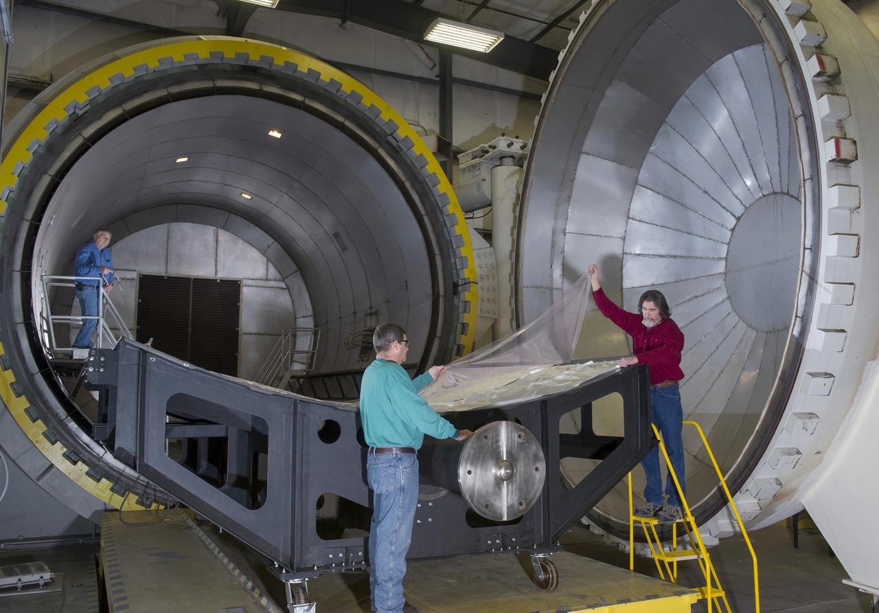 JAMES NEWTON, LEFT, PHILLIP THOMPSON, CENTER, AND DAVID LAWRENCE, RIGHT PREPARE COMPOSITE TOOL FOR CURE IN 18' X 20' AUTOCLAVE IN BUILDING 4707