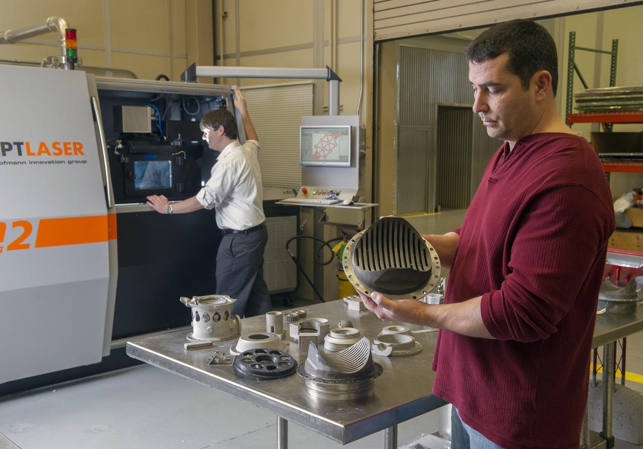 ZACK JONES AND JIM LYDON OF MSFC’S ADVANCED MANUFACTURING TEAM, WITH MSFC’S M2 SELECTIVE LASER MELTING SYSTEM.  THE M2 IS CURRENTLY DEDICATED TO ADVANCED COPPER MATERIAL DEVELOPMENT FOR THE LOW COST UPPER STAGE PROGRAM.