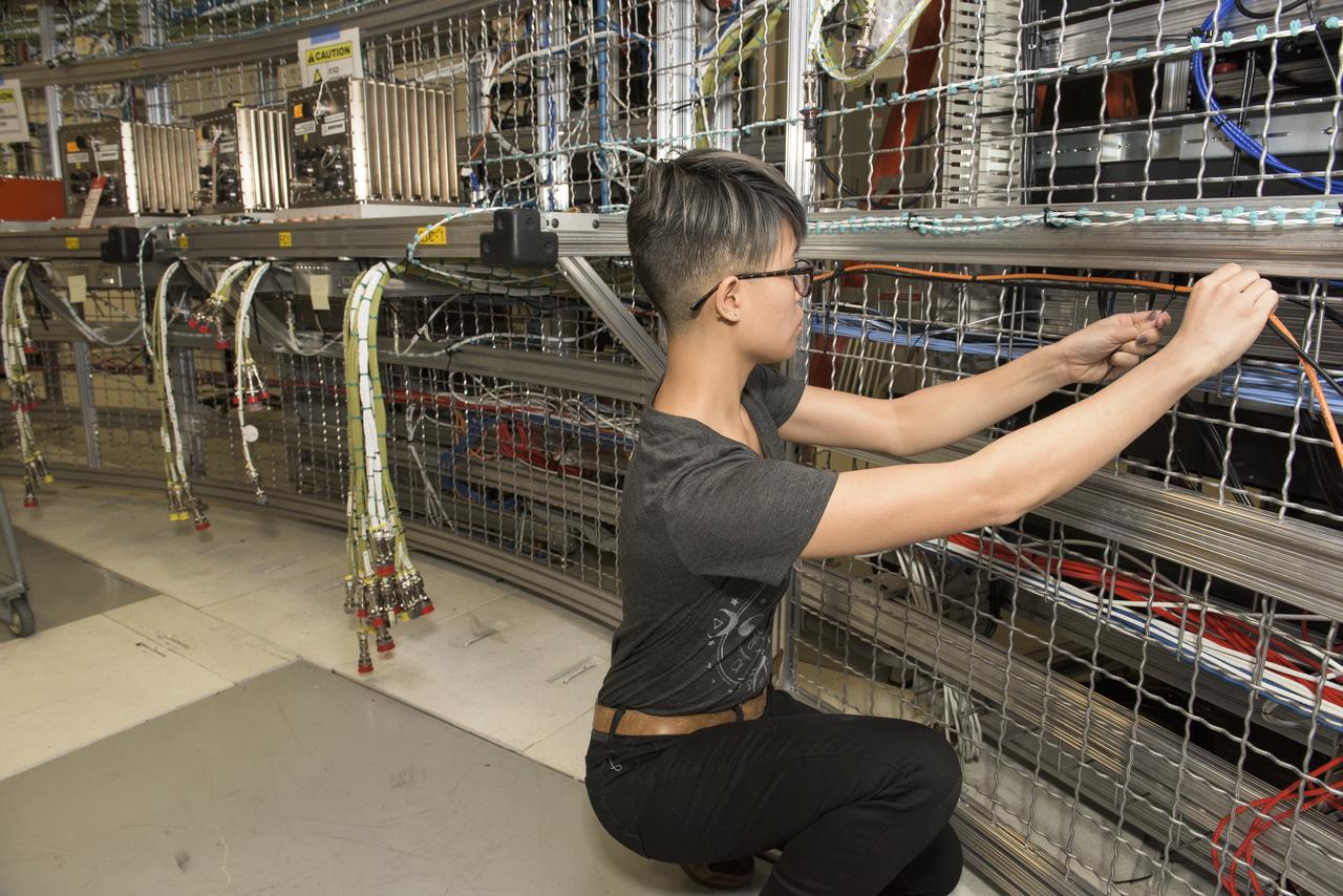 RATANA MACKRELL POSITIONS CABLES IN THE SYSTEMS INTEGRATION AND TEST FACILITY