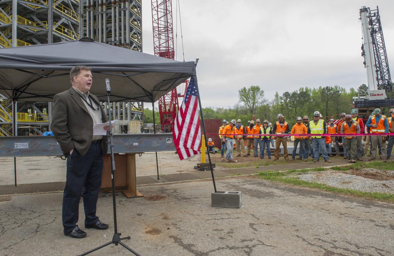 BOB DEVLIN, DEPUTY DIRECTOR OF MARSHALL'S OFFICE OF CENTER OPERATIONS, SPEAKS TO THE CROWD IN FRONT OF A STEEL BEAM DESTINED FOR TEST STAND 4693 DURING THE STRUCTURE'S TOPPING OUT CEREMONY APRIL 12.