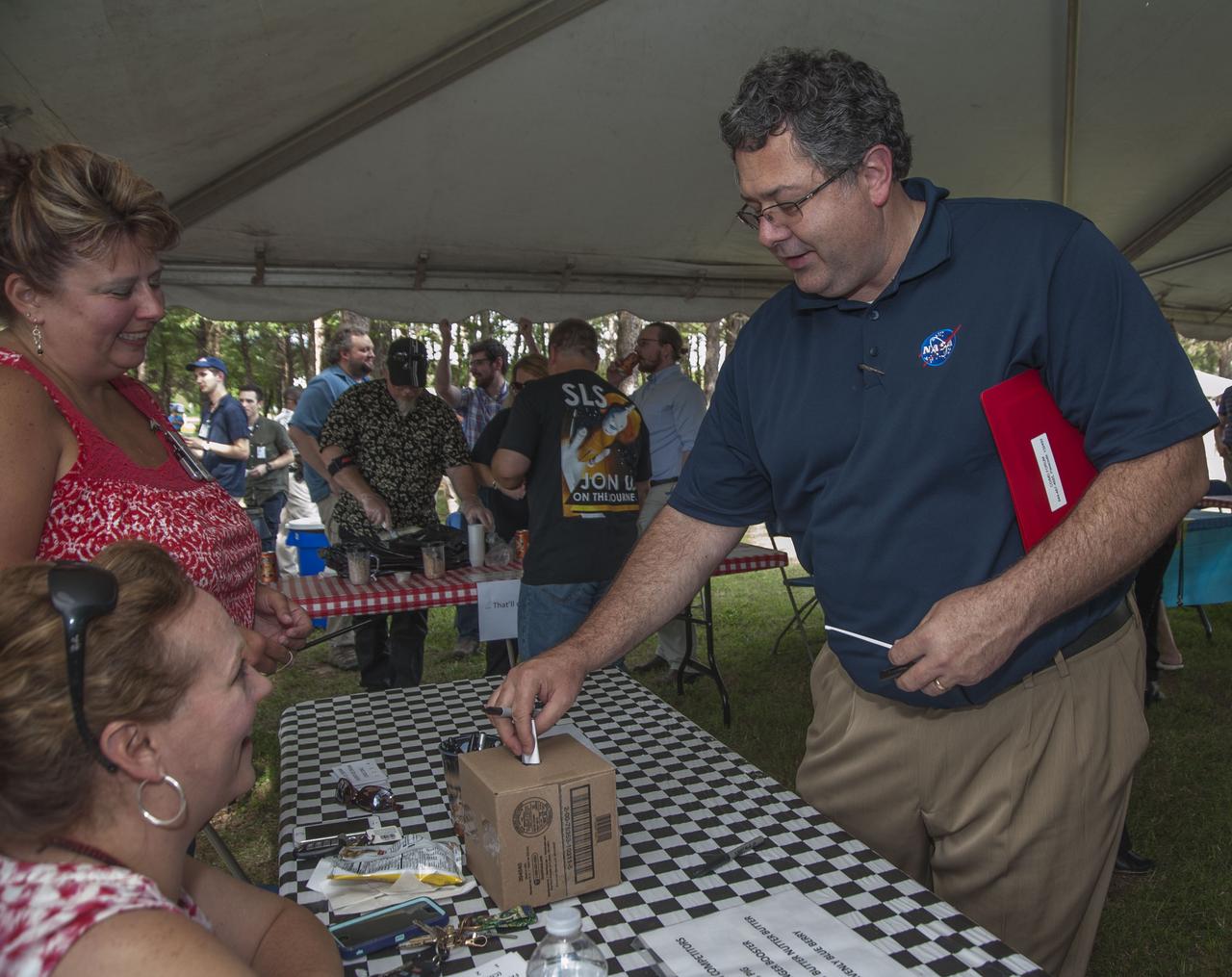 MARSHALL SPACE FLIGHT CENTER DIRECTOR TODD MAY CASTS HIS BALLOT IN THE HOMEMADE ICE CREAM CONTEST DURING THE GREAT EXCHANGE SUMMER BLAST SOCIAL, PRESENTED JUNE 9 BY THE MARSHALL EXCHANGE. THE EXCHANGE IS A NON-APPROPRIATED-FUND ACTIVITY THAT AIMS TO CONTRIBUTE TO THE WELFARE, EFFICIENCY AND MORALE OF MARSHALL TEAM MEMBERS, OTHER GOVERNMENT PERSONNEL, RETIRED NASA EMPLOYEES AND THEIR FAMILIES.