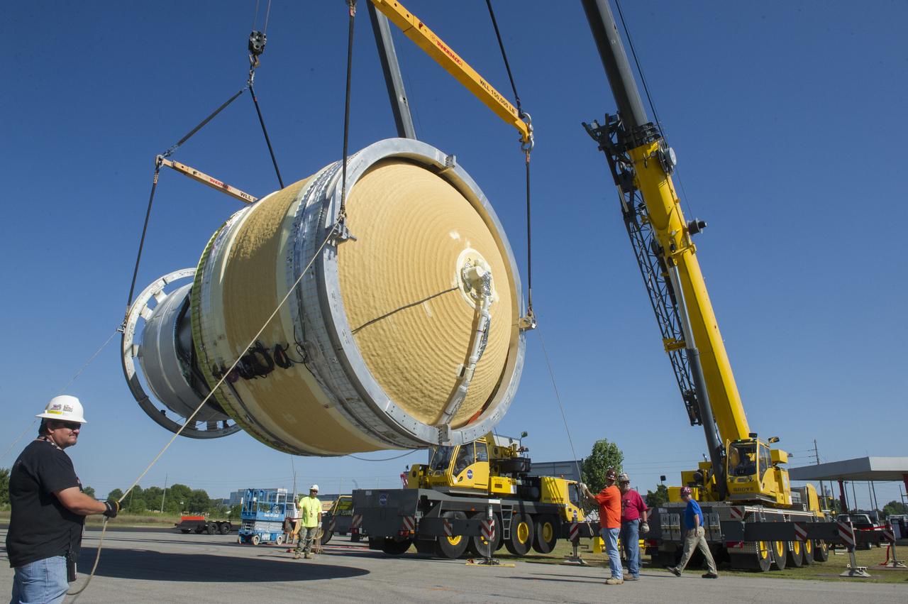 TWO CRANES LIFT THE APPROXIMATELY 8,000-POUND INTERIM CRYOGENIC PROPULSION STAGE TEST ARTICLE OUT OF ITS CRATE AT MARSHALL. THE TEST ARTICLE ARRIVED AT MARSHALL SPACE FLIGHT CENTER VIA BARGE ON THE TENNESSEE RIVER AND WAS TRANSPORTED TO BUILDING 4649 WHERE TESTING WILL BEGIN.