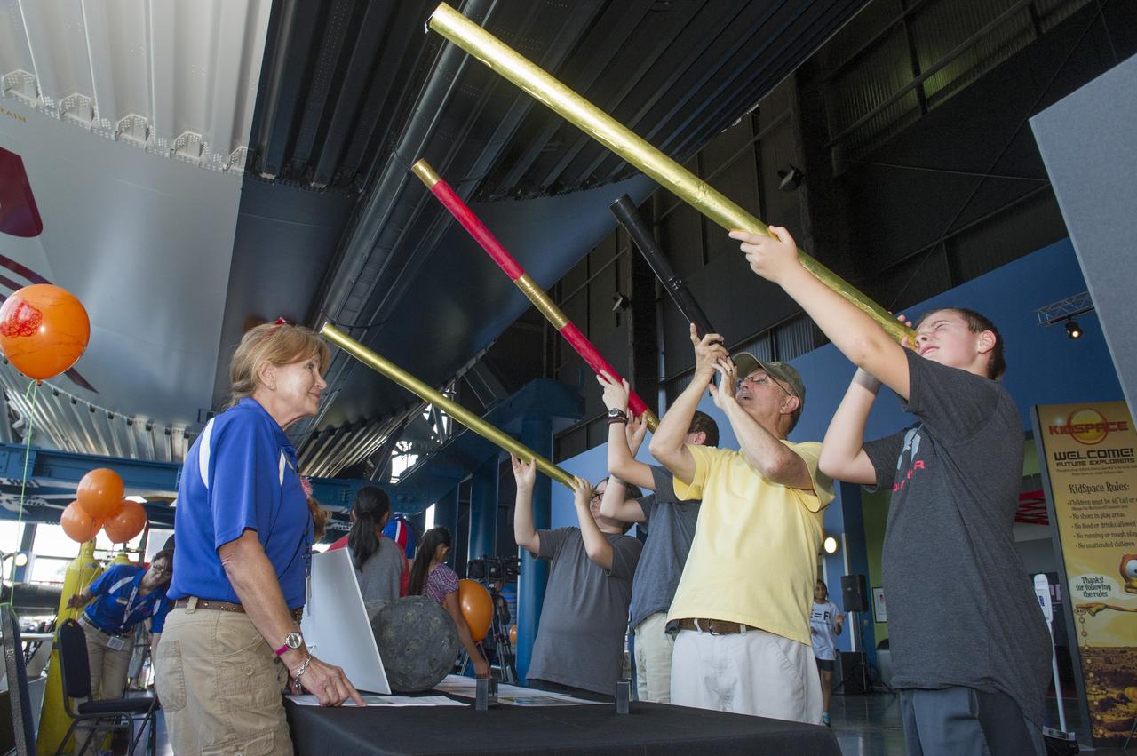 JOHN TUCKER AND HIS THREE GRANDSONS VIEW JUPITER SIMULATION THROUGH TELESCOPES