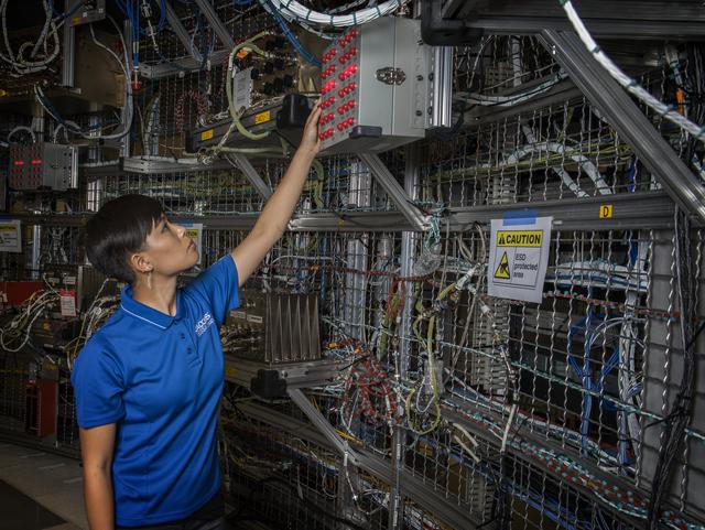 NASA image: RATANA MEEKHAM, AN ELECTRICAL INTEGRATION TECHNICIAN FOR QUALIS CORP. OF HUNTSVILLE, ALABAMA, HELPS TEST AVIONICS -- COMPLEX VEHICLE SYSTEMS ENABLING NAVIGATION, COMMUNICATIONS AND OTHER FUNCTIONS CRITICAL TO HUMAN SPACEFLIGHT
