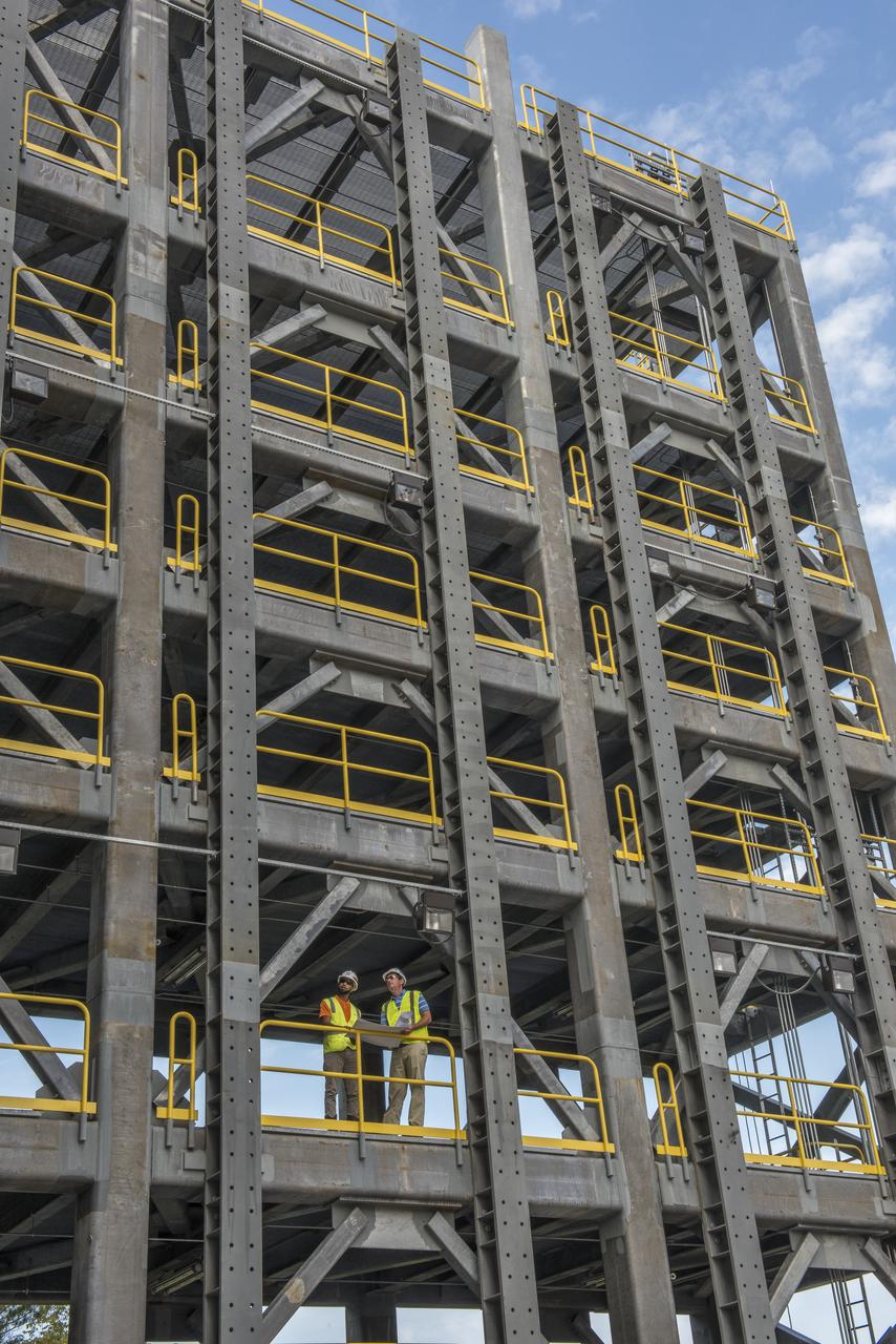 AS THE END OF CONSTRUCTION ON TEST STAND 4697, THE LIQUID OXYGEN TANK TEST STAND AT MARSHALL SPACE FLIGHT CENTER, PROJECT ENGINEERS PHIL HENDRIX, FROM MSFC, AND CURTNEY WALTERS FROM THE U.S. CORP OF ENGINEERS, STUDY PLANS AND PROGRESS.