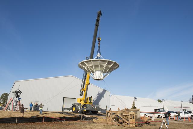 NASA image: SETTING A NEW SATELLITE RECEIVING ANTENNA