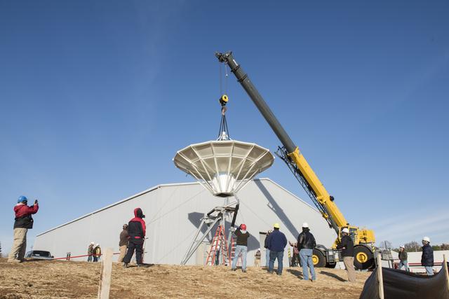 NASA image: SETTING A NEW SATELLITE RECEIVING ANTENNA