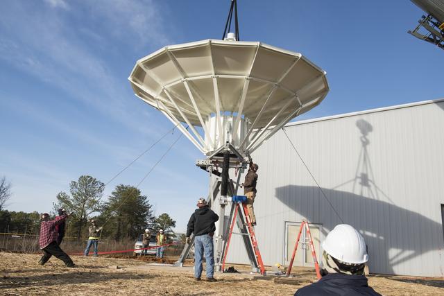 NASA image: SETTING A NEW SATELLITE RECEIVING ANTENNA