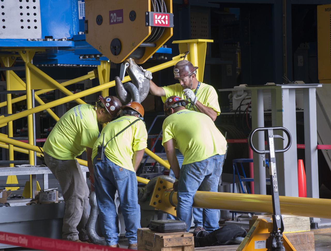 NASA engineers install test hardware for the agency's new heavy lift rocket, the Space Launch System, into a newly constructed 50-foot structural test stand at NASA's Marshall Space Flight Center. In the stand, hydraulic cylinders will be electronically controlled to push, pull, twist and bend the test article with millions of pounds of force. Engineers will record and analyze over 3,000 channels of data for each test case to verify the capabilities of the engine section and validate that the design and analysis models accurately predict the amount of loads the core stage can withstand during launch and ascent. The engine section, recently delivered via NASA's barge Pegasus from NASA's Michoud Assembly Facility, is the first of four core stage structural test articles scheduled to be delivered to Marshall for testing. The engine section, located at the bottom of SLS's massive core stage, will house the rocket's four RS-25 engines and be an attachment point for the two solid rocket boosters.