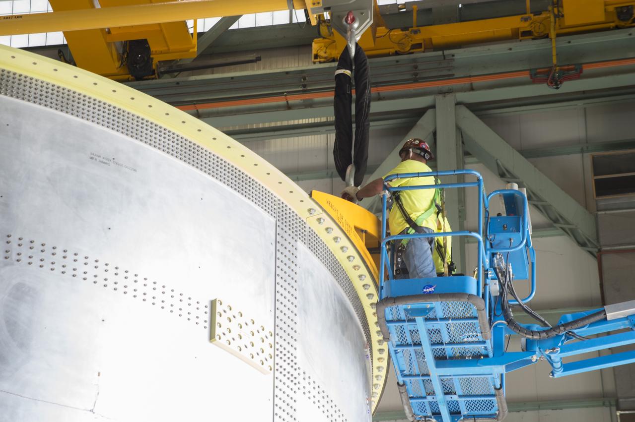 NASA engineers install test hardware for the agency's new heavy lift rocket, the Space Launch System, into a newly constructed 50-foot structural test stand at NASA's Marshall Space Flight Center. In the stand, hydraulic cylinders will be electronically controlled to push, pull, twist and bend the test article with millions of pounds of force. Engineers will record and analyze over 3,000 channels of data for each test case to verify the capabilities of the engine section and validate that the design and analysis models accurately predict the amount of loads the core stage can withstand during launch and ascent. The engine section, recently delivered via NASA's barge Pegasus from NASA's Michoud Assembly Facility, is the first of four core stage structural test articles scheduled to be delivered to Marshall for testing. The engine section, located at the bottom of SLS's massive core stage, will house the rocket's four RS-25 engines and be an attachment point for the two solid rocket boosters.
