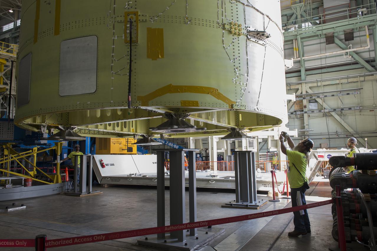 NASA engineers install test hardware for the agency's new heavy lift rocket, the Space Launch System, into a newly constructed 50-foot structural test stand at NASA's Marshall Space Flight Center. In the stand, hydraulic cylinders will be electronically controlled to push, pull, twist and bend the test article with millions of pounds of force. Engineers will record and analyze over 3,000 channels of data for each test case to verify the capabilities of the engine section and validate that the design and analysis models accurately predict the amount of loads the core stage can withstand during launch and ascent. The engine section, recently delivered via NASA's barge Pegasus from NASA's Michoud Assembly Facility, is the first of four core stage structural test articles scheduled to be delivered to Marshall for testing. The engine section, located at the bottom of SLS's massive core stage, will house the rocket's four RS-25 engines and be an attachment point for the two solid rocket boosters.