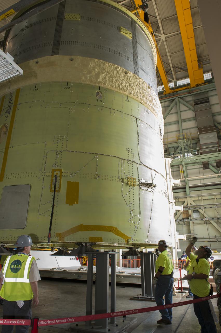 NASA engineers install test hardware for the agency's new heavy lift rocket, the Space Launch System, into a newly constructed 50-foot structural test stand at NASA's Marshall Space Flight Center. In the stand, hydraulic cylinders will be electronically controlled to push, pull, twist and bend the test article with millions of pounds of force. Engineers will record and analyze over 3,000 channels of data for each test case to verify the capabilities of the engine section and validate that the design and analysis models accurately predict the amount of loads the core stage can withstand during launch and ascent. The engine section, recently delivered via NASA's barge Pegasus from NASA's Michoud Assembly Facility, is the first of four core stage structural test articles scheduled to be delivered to Marshall for testing. The engine section, located at the bottom of SLS's massive core stage, will house the rocket's four RS-25 engines and be an attachment point for the two solid rocket boosters.