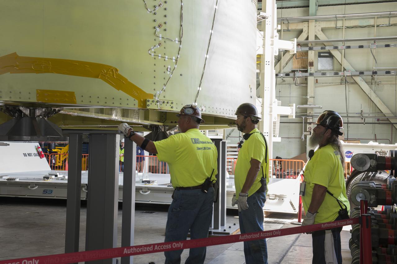 NASA engineers install test hardware for the agency's new heavy lift rocket, the Space Launch System, into a newly constructed 50-foot structural test stand at NASA's Marshall Space Flight Center. In the stand, hydraulic cylinders will be electronically controlled to push, pull, twist and bend the test article with millions of pounds of force. Engineers will record and analyze over 3,000 channels of data for each test case to verify the capabilities of the engine section and validate that the design and analysis models accurately predict the amount of loads the core stage can withstand during launch and ascent. The engine section, recently delivered via NASA's barge Pegasus from NASA's Michoud Assembly Facility, is the first of four core stage structural test articles scheduled to be delivered to Marshall for testing. The engine section, located at the bottom of SLS's massive core stage, will house the rocket's four RS-25 engines and be an attachment point for the two solid rocket boosters.