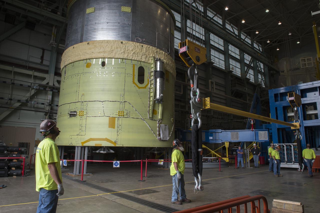 NASA engineers install test hardware for the agency's new heavy lift rocket, the Space Launch System, into a newly constructed 50-foot structural test stand at NASA's Marshall Space Flight Center. In the stand, hydraulic cylinders will be electronically controlled to push, pull, twist and bend the test article with millions of pounds of force. Engineers will record and analyze over 3,000 channels of data for each test case to verify the capabilities of the engine section and validate that the design and analysis models accurately predict the amount of loads the core stage can withstand during launch and ascent. The engine section, recently delivered via NASA's barge Pegasus from NASA's Michoud Assembly Facility, is the first of four core stage structural test articles scheduled to be delivered to Marshall for testing. The engine section, located at the bottom of SLS's massive core stage, will house the rocket's four RS-25 engines and be an attachment point for the two solid rocket boosters.