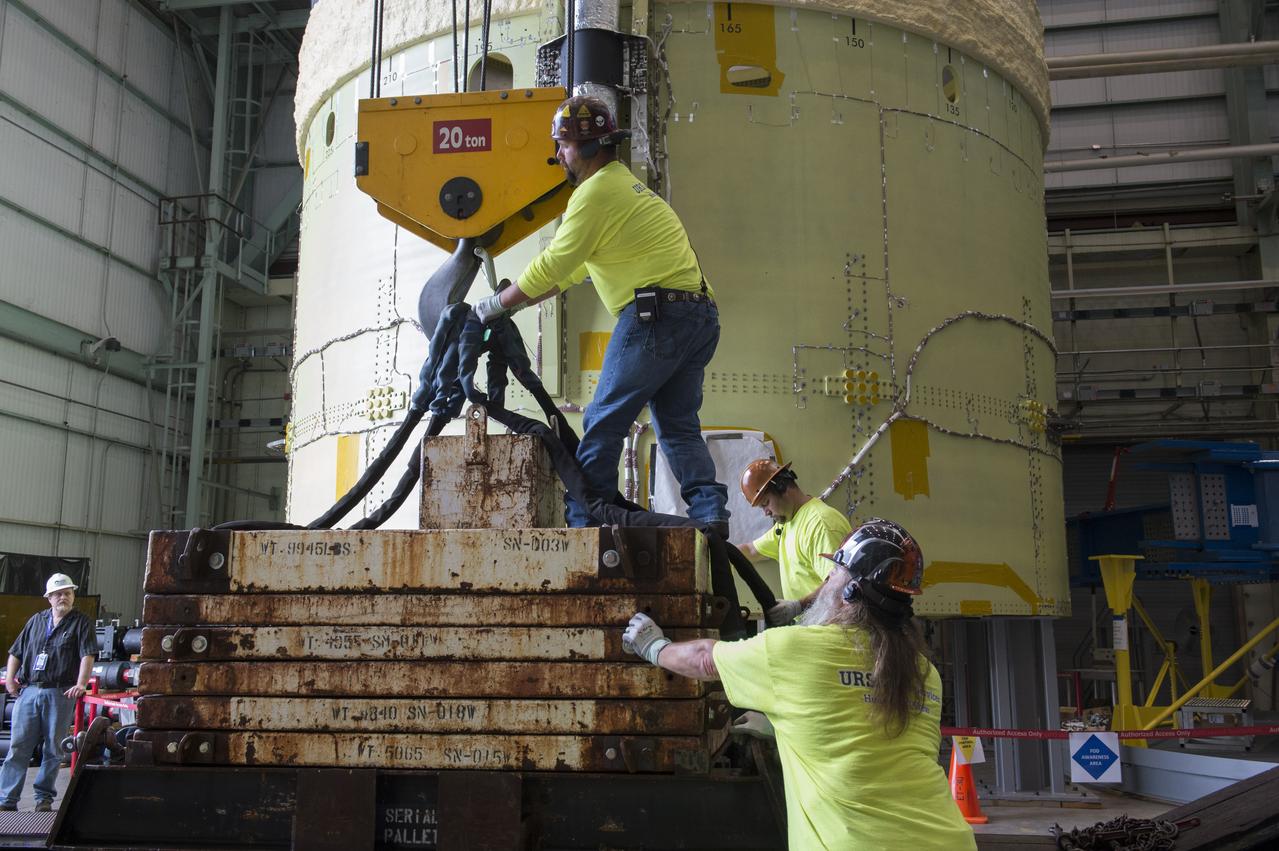 NASA engineers install test hardware for the agency's new heavy lift rocket, the Space Launch System, into a newly constructed 50-foot structural test stand at NASA's Marshall Space Flight Center. In the stand, hydraulic cylinders will be electronically controlled to push, pull, twist and bend the test article with millions of pounds of force. Engineers will record and analyze over 3,000 channels of data for each test case to verify the capabilities of the engine section and validate that the design and analysis models accurately predict the amount of loads the core stage can withstand during launch and ascent. The engine section, recently delivered via NASA's barge Pegasus from NASA's Michoud Assembly Facility, is the first of four core stage structural test articles scheduled to be delivered to Marshall for testing. The engine section, located at the bottom of SLS's massive core stage, will house the rocket's four RS-25 engines and be an attachment point for the two solid rocket boosters.