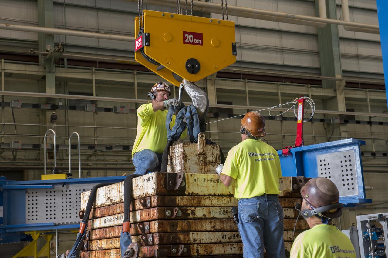 NASA engineers install test hardware for the agency's new heavy lift rocket, the Space Launch System, into a newly constructed 50-foot structural test stand at NASA's Marshall Space Flight Center. In the stand, hydraulic cylinders will be electronically controlled to push, pull, twist and bend the test article with millions of pounds of force. Engineers will record and analyze over 3,000 channels of data for each test case to verify the capabilities of the engine section and validate that the design and analysis models accurately predict the amount of loads the core stage can withstand during launch and ascent. The engine section, recently delivered via NASA's barge Pegasus from NASA's Michoud Assembly Facility, is the first of four core stage structural test articles scheduled to be delivered to Marshall for testing. The engine section, located at the bottom of SLS's massive core stage, will house the rocket's four RS-25 engines and be an attachment point for the two solid rocket boosters.