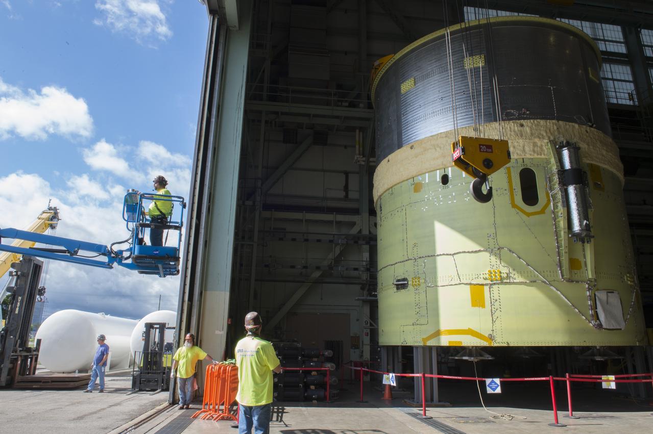 NASA engineers install test hardware for the agency's new heavy lift rocket, the Space Launch System, into a newly constructed 50-foot structural test stand at NASA's Marshall Space Flight Center. In the stand, hydraulic cylinders will be electronically controlled to push, pull, twist and bend the test article with millions of pounds of force. Engineers will record and analyze over 3,000 channels of data for each test case to verify the capabilities of the engine section and validate that the design and analysis models accurately predict the amount of loads the core stage can withstand during launch and ascent. The engine section, recently delivered via NASA's barge Pegasus from NASA's Michoud Assembly Facility, is the first of four core stage structural test articles scheduled to be delivered to Marshall for testing. The engine section, located at the bottom of SLS's massive core stage, will house the rocket's four RS-25 engines and be an attachment point for the two solid rocket boosters.