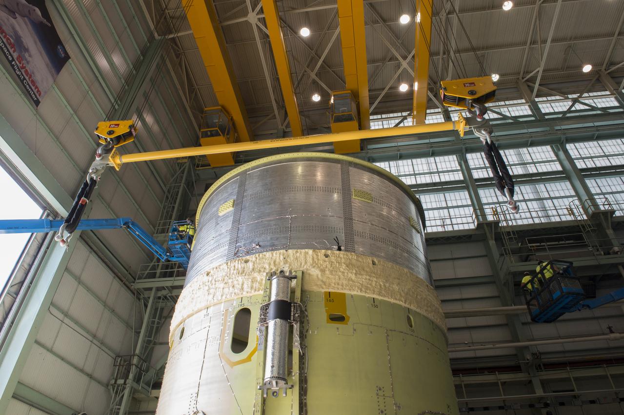 NASA engineers install test hardware for the agency's new heavy lift rocket, the Space Launch System, into a newly constructed 50-foot structural test stand at NASA's Marshall Space Flight Center. In the stand, hydraulic cylinders will be electronically controlled to push, pull, twist and bend the test article with millions of pounds of force. Engineers will record and analyze over 3,000 channels of data for each test case to verify the capabilities of the engine section and validate that the design and analysis models accurately predict the amount of loads the core stage can withstand during launch and ascent. The engine section, recently delivered via NASA's barge Pegasus from NASA's Michoud Assembly Facility, is the first of four core stage structural test articles scheduled to be delivered to Marshall for testing. The engine section, located at the bottom of SLS's massive core stage, will house the rocket's four RS-25 engines and be an attachment point for the two solid rocket boosters.