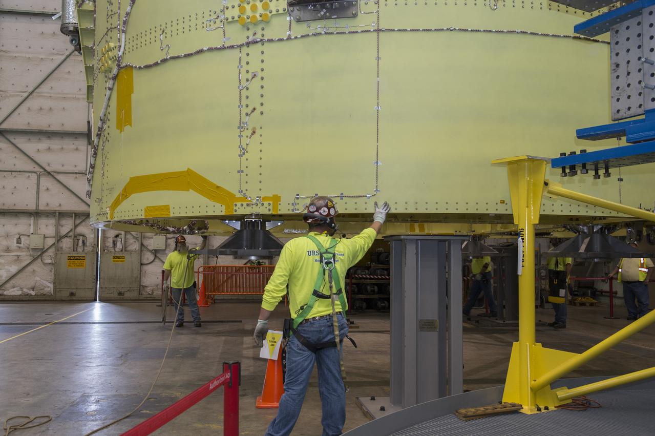 NASA engineers install test hardware for the agency's new heavy lift rocket, the Space Launch System, into a newly constructed 50-foot structural test stand at NASA's Marshall Space Flight Center. In the stand, hydraulic cylinders will be electronically controlled to push, pull, twist and bend the test article with millions of pounds of force. Engineers will record and analyze over 3,000 channels of data for each test case to verify the capabilities of the engine section and validate that the design and analysis models accurately predict the amount of loads the core stage can withstand during launch and ascent. The engine section, recently delivered via NASA's barge Pegasus from NASA's Michoud Assembly Facility, is the first of four core stage structural test articles scheduled to be delivered to Marshall for testing. The engine section, located at the bottom of SLS's massive core stage, will house the rocket's four RS-25 engines and be an attachment point for the two solid rocket boosters.