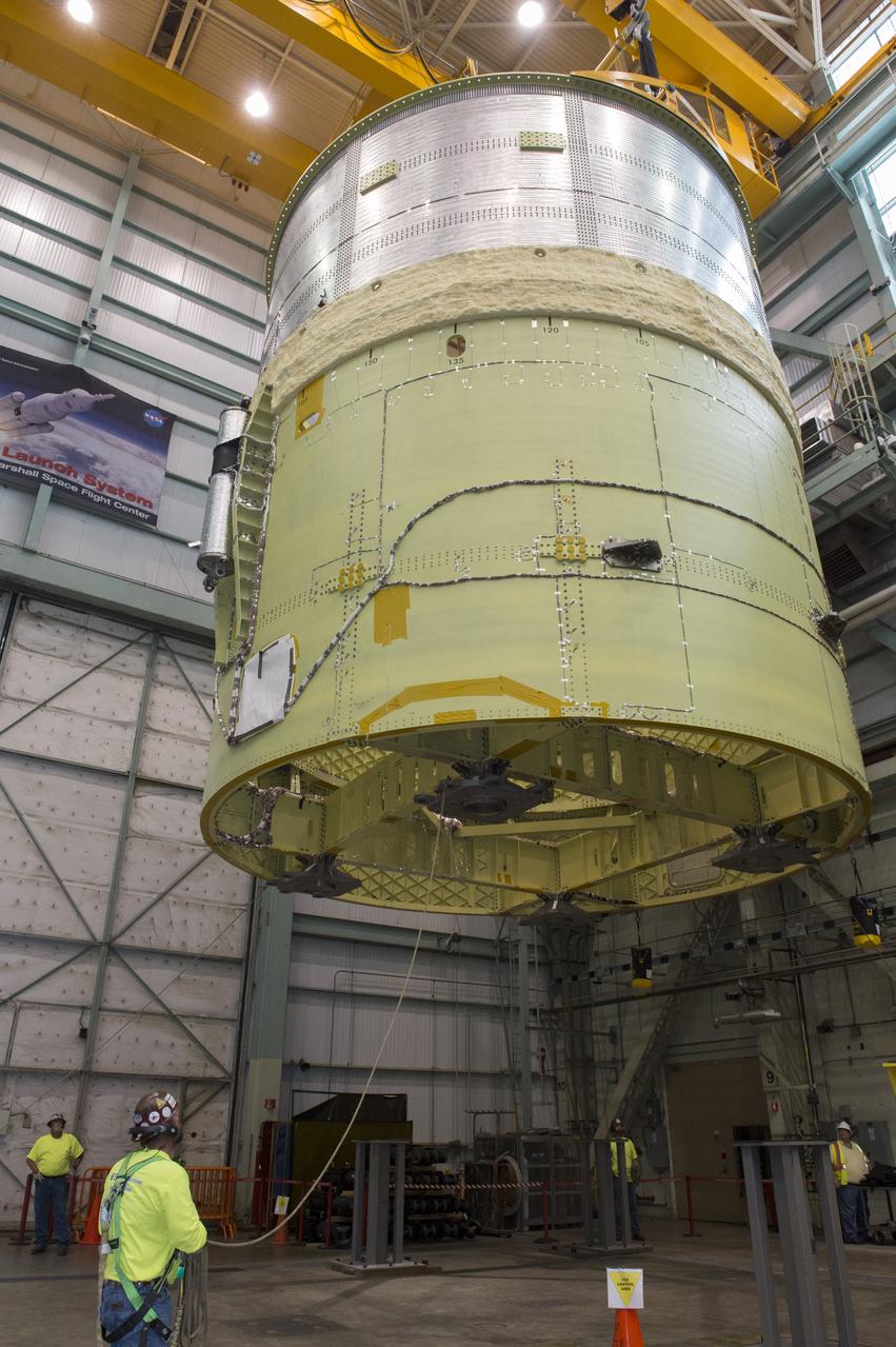 NASA engineers install test hardware for the agency's new heavy lift rocket, the Space Launch System, into a newly constructed 50-foot structural test stand at NASA's Marshall Space Flight Center. In the stand, hydraulic cylinders will be electronically controlled to push, pull, twist and bend the test article with millions of pounds of force. Engineers will record and analyze over 3,000 channels of data for each test case to verify the capabilities of the engine section and validate that the design and analysis models accurately predict the amount of loads the core stage can withstand during launch and ascent. The engine section, recently delivered via NASA's barge Pegasus from NASA's Michoud Assembly Facility, is the first of four core stage structural test articles scheduled to be delivered to Marshall for testing. The engine section, located at the bottom of SLS's massive core stage, will house the rocket's four RS-25 engines and be an attachment point for the two solid rocket boosters.
