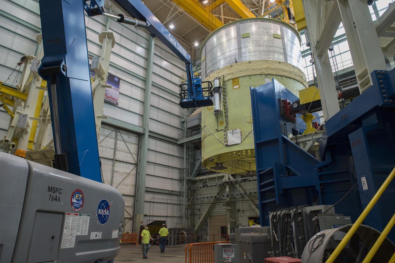 NASA engineers install test hardware for the agency's new heavy lift rocket, the Space Launch System, into a newly constructed 50-foot structural test stand at NASA's Marshall Space Flight Center. In the stand, hydraulic cylinders will be electronically controlled to push, pull, twist and bend the test article with millions of pounds of force. Engineers will record and analyze over 3,000 channels of data for each test case to verify the capabilities of the engine section and validate that the design and analysis models accurately predict the amount of loads the core stage can withstand during launch and ascent. The engine section, recently delivered via NASA's barge Pegasus from NASA's Michoud Assembly Facility, is the first of four core stage structural test articles scheduled to be delivered to Marshall for testing. The engine section, located at the bottom of SLS's massive core stage, will house the rocket's four RS-25 engines and be an attachment point for the two solid rocket boosters.