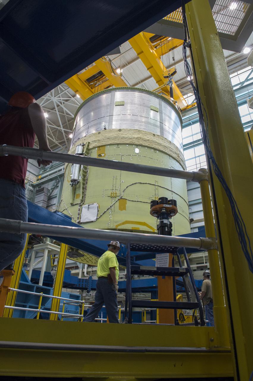NASA engineers install test hardware for the agency's new heavy lift rocket, the Space Launch System, into a newly constructed 50-foot structural test stand at NASA's Marshall Space Flight Center. In the stand, hydraulic cylinders will be electronically controlled to push, pull, twist and bend the test article with millions of pounds of force. Engineers will record and analyze over 3,000 channels of data for each test case to verify the capabilities of the engine section and validate that the design and analysis models accurately predict the amount of loads the core stage can withstand during launch and ascent. The engine section, recently delivered via NASA's barge Pegasus from NASA's Michoud Assembly Facility, is the first of four core stage structural test articles scheduled to be delivered to Marshall for testing. The engine section, located at the bottom of SLS's massive core stage, will house the rocket's four RS-25 engines and be an attachment point for the two solid rocket boosters.