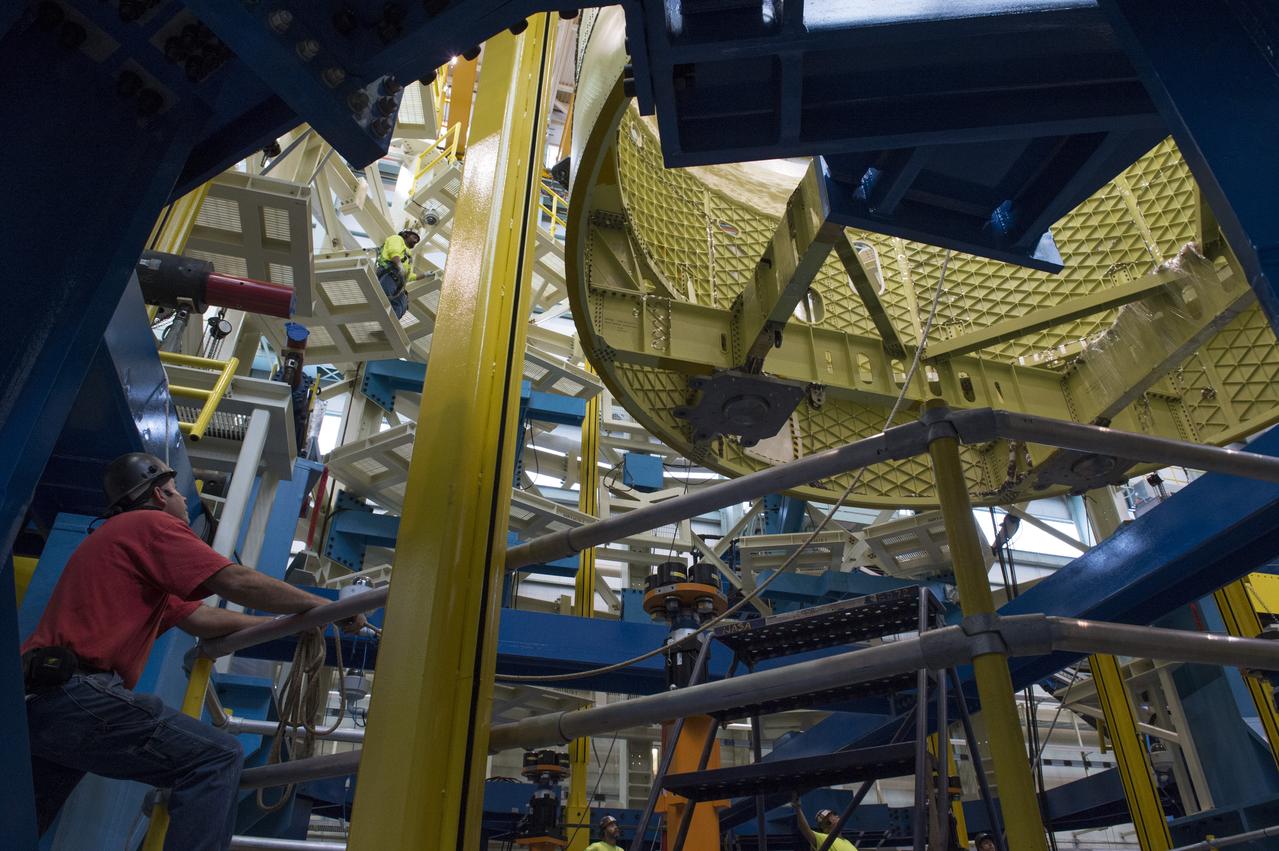 NASA engineers install test hardware for the agency's new heavy lift rocket, the Space Launch System, into a newly constructed 50-foot structural test stand at NASA's Marshall Space Flight Center. In the stand, hydraulic cylinders will be electronically controlled to push, pull, twist and bend the test article with millions of pounds of force. Engineers will record and analyze over 3,000 channels of data for each test case to verify the capabilities of the engine section and validate that the design and analysis models accurately predict the amount of loads the core stage can withstand during launch and ascent. The engine section, recently delivered via NASA's barge Pegasus from NASA's Michoud Assembly Facility, is the first of four core stage structural test articles scheduled to be delivered to Marshall for testing. The engine section, located at the bottom of SLS's massive core stage, will house the rocket's four RS-25 engines and be an attachment point for the two solid rocket boosters.