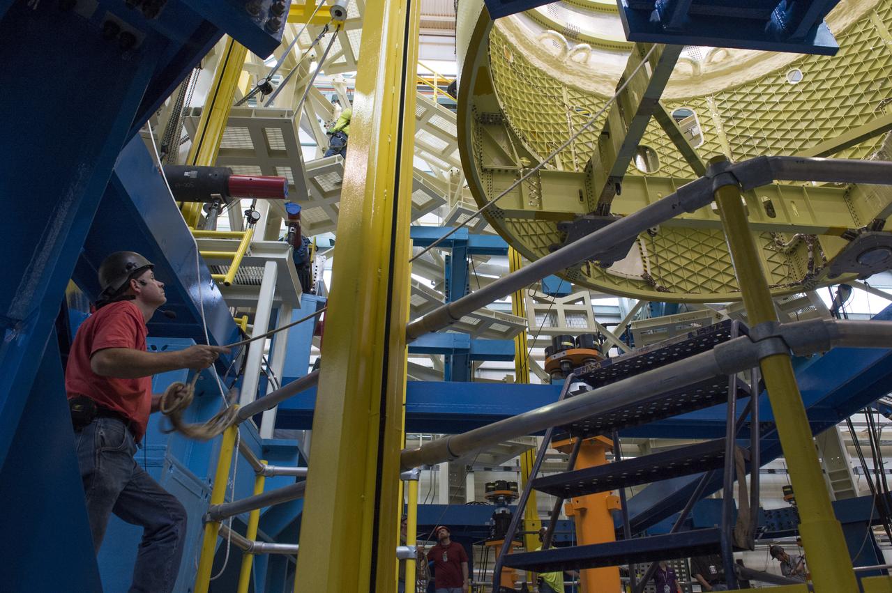 NASA engineers install test hardware for the agency's new heavy lift rocket, the Space Launch System, into a newly constructed 50-foot structural test stand at NASA's Marshall Space Flight Center. In the stand, hydraulic cylinders will be electronically controlled to push, pull, twist and bend the test article with millions of pounds of force. Engineers will record and analyze over 3,000 channels of data for each test case to verify the capabilities of the engine section and validate that the design and analysis models accurately predict the amount of loads the core stage can withstand during launch and ascent. The engine section, recently delivered via NASA's barge Pegasus from NASA's Michoud Assembly Facility, is the first of four core stage structural test articles scheduled to be delivered to Marshall for testing. The engine section, located at the bottom of SLS's massive core stage, will house the rocket's four RS-25 engines and be an attachment point for the two solid rocket boosters.