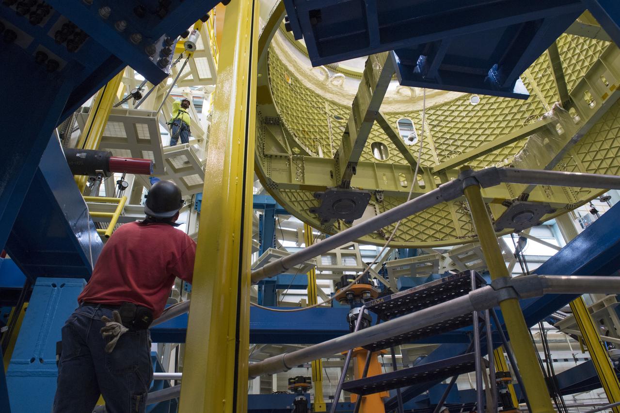 NASA engineers install test hardware for the agency's new heavy lift rocket, the Space Launch System, into a newly constructed 50-foot structural test stand at NASA's Marshall Space Flight Center. In the stand, hydraulic cylinders will be electronically controlled to push, pull, twist and bend the test article with millions of pounds of force. Engineers will record and analyze over 3,000 channels of data for each test case to verify the capabilities of the engine section and validate that the design and analysis models accurately predict the amount of loads the core stage can withstand during launch and ascent. The engine section, recently delivered via NASA's barge Pegasus from NASA's Michoud Assembly Facility, is the first of four core stage structural test articles scheduled to be delivered to Marshall for testing. The engine section, located at the bottom of SLS's massive core stage, will house the rocket's four RS-25 engines and be an attachment point for the two solid rocket boosters.