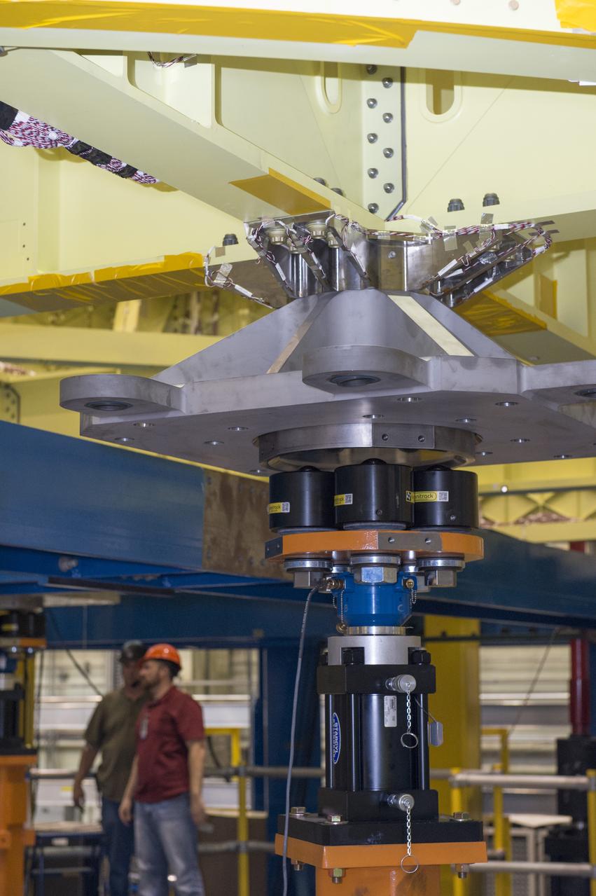 NASA engineers install test hardware for the agency's new heavy lift rocket, the Space Launch System, into a newly constructed 50-foot structural test stand at NASA's Marshall Space Flight Center. In the stand, hydraulic cylinders will be electronically controlled to push, pull, twist and bend the test article with millions of pounds of force. Engineers will record and analyze over 3,000 channels of data for each test case to verify the capabilities of the engine section and validate that the design and analysis models accurately predict the amount of loads the core stage can withstand during launch and ascent. The engine section, recently delivered via NASA's barge Pegasus from NASA's Michoud Assembly Facility, is the first of four core stage structural test articles scheduled to be delivered to Marshall for testing. The engine section, located at the bottom of SLS's massive core stage, will house the rocket's four RS-25 engines and be an attachment point for the two solid rocket boosters.