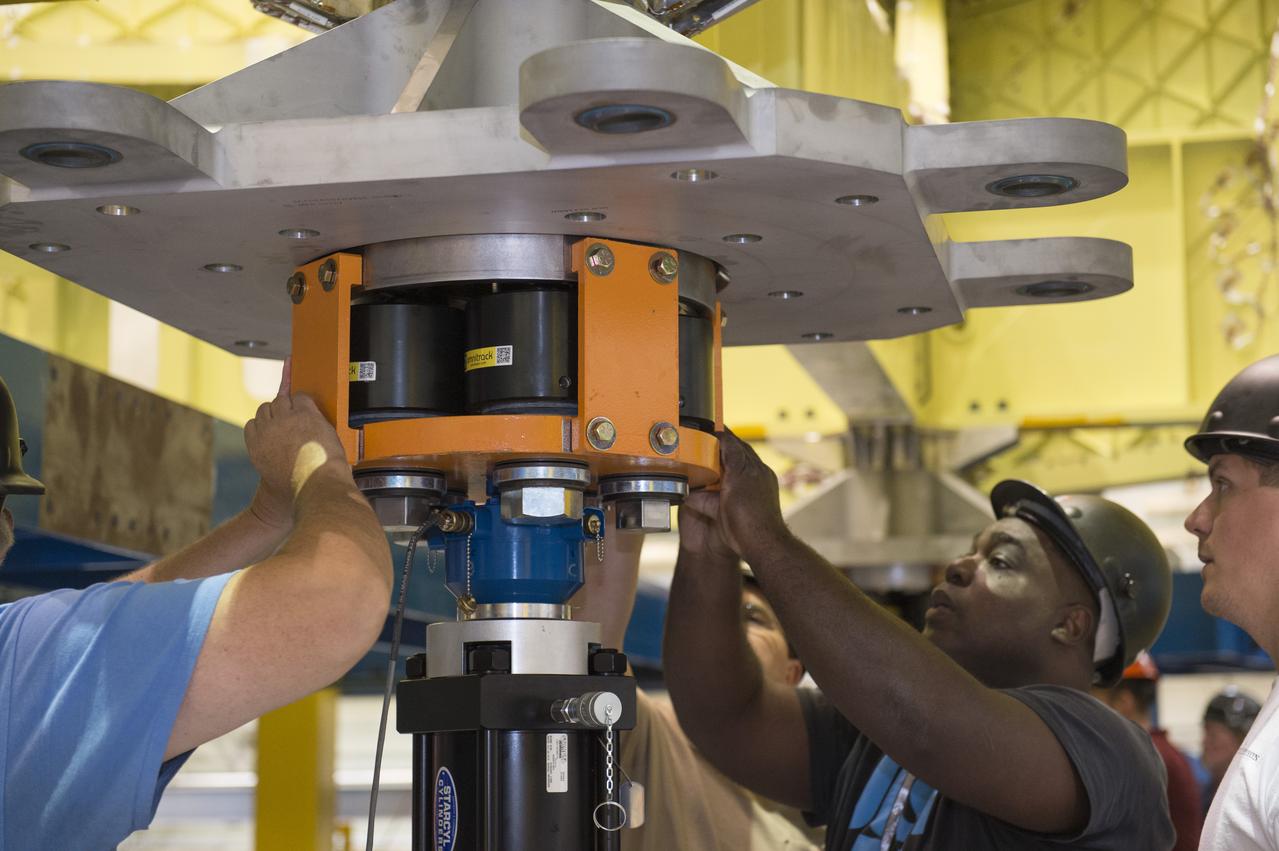 NASA engineers install test hardware for the agency's new heavy lift rocket, the Space Launch System, into a newly constructed 50-foot structural test stand at NASA's Marshall Space Flight Center. In the stand, hydraulic cylinders will be electronically controlled to push, pull, twist and bend the test article with millions of pounds of force. Engineers will record and analyze over 3,000 channels of data for each test case to verify the capabilities of the engine section and validate that the design and analysis models accurately predict the amount of loads the core stage can withstand during launch and ascent. The engine section, recently delivered via NASA's barge Pegasus from NASA's Michoud Assembly Facility, is the first of four core stage structural test articles scheduled to be delivered to Marshall for testing. The engine section, located at the bottom of SLS's massive core stage, will house the rocket's four RS-25 engines and be an attachment point for the two solid rocket boosters.