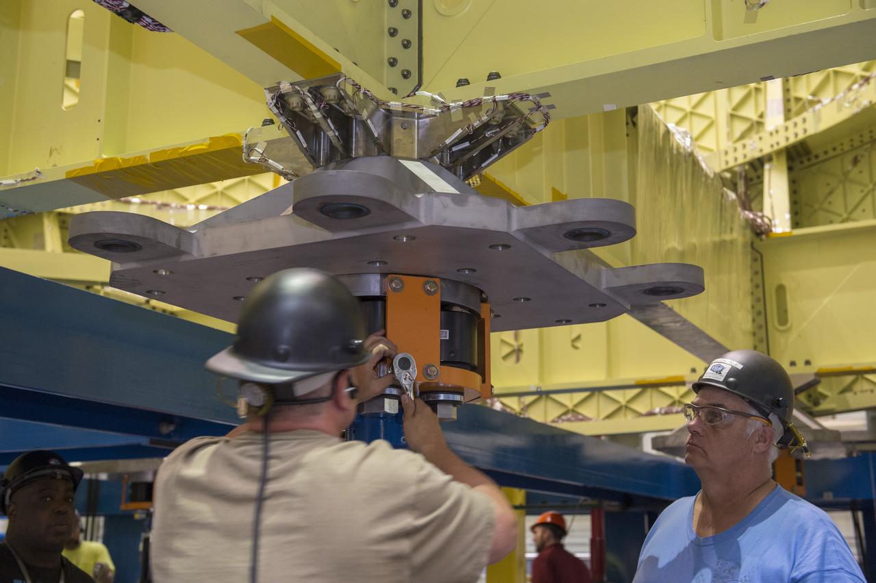 NASA engineers install test hardware for the agency's new heavy lift rocket, the Space Launch System, into a newly constructed 50-foot structural test stand at NASA's Marshall Space Flight Center. In the stand, hydraulic cylinders will be electronically controlled to push, pull, twist and bend the test article with millions of pounds of force. Engineers will record and analyze over 3,000 channels of data for each test case to verify the capabilities of the engine section and validate that the design and analysis models accurately predict the amount of loads the core stage can withstand during launch and ascent. The engine section, recently delivered via NASA's barge Pegasus from NASA's Michoud Assembly Facility, is the first of four core stage structural test articles scheduled to be delivered to Marshall for testing. The engine section, located at the bottom of SLS's massive core stage, will house the rocket's four RS-25 engines and be an attachment point for the two solid rocket boosters.