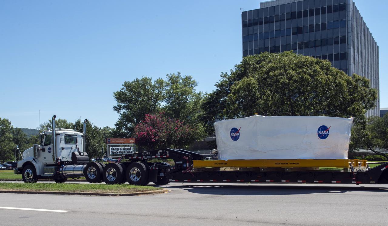 The Orion stage adapter being transported from Marshall Space Flight Center to Redstone Arsenal's airfield for transportation on NASA's Guppie aircraft to Denver, Colorado for further testing.