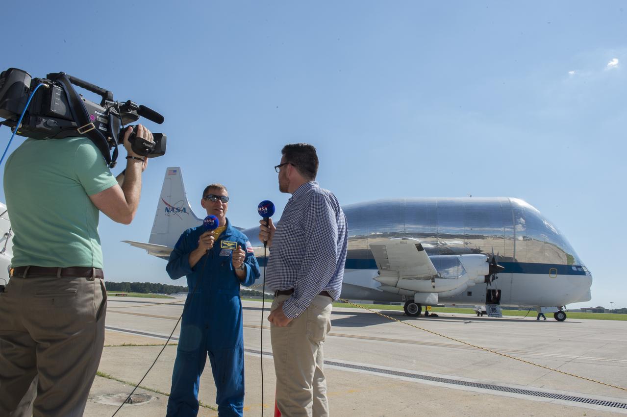 Marshall Space Flight Center public affairs officer, Brian Massey, interviews Gregory Johnson, NASA's Super Guppie pilot, after the arrival of the aircraft to ferry the Orion stage adapter to Denver, Colorado for further testing.