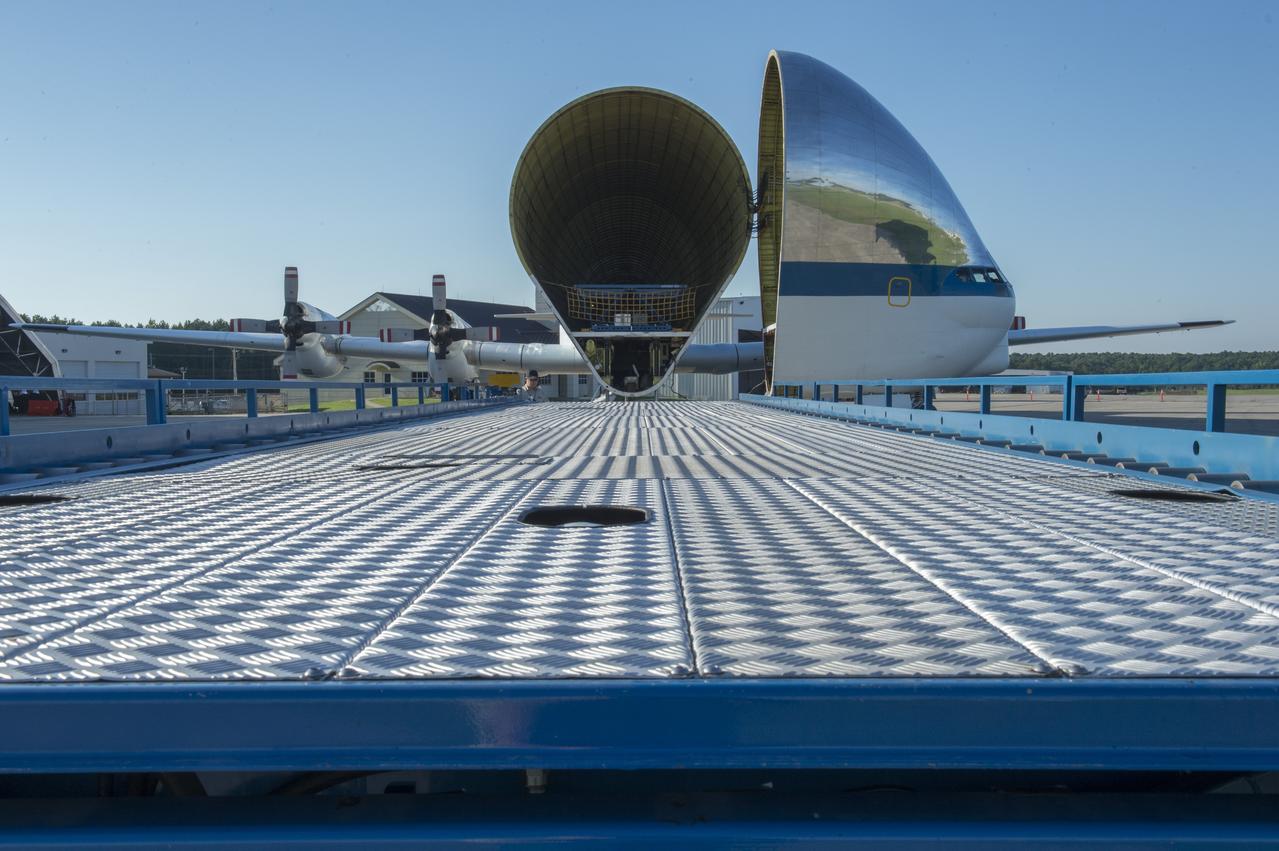 The platform which will be used to load the Orion stage adapter into NASA's Super Guppie aircraft is shown in the foreground with the Guppie aircraft in the background