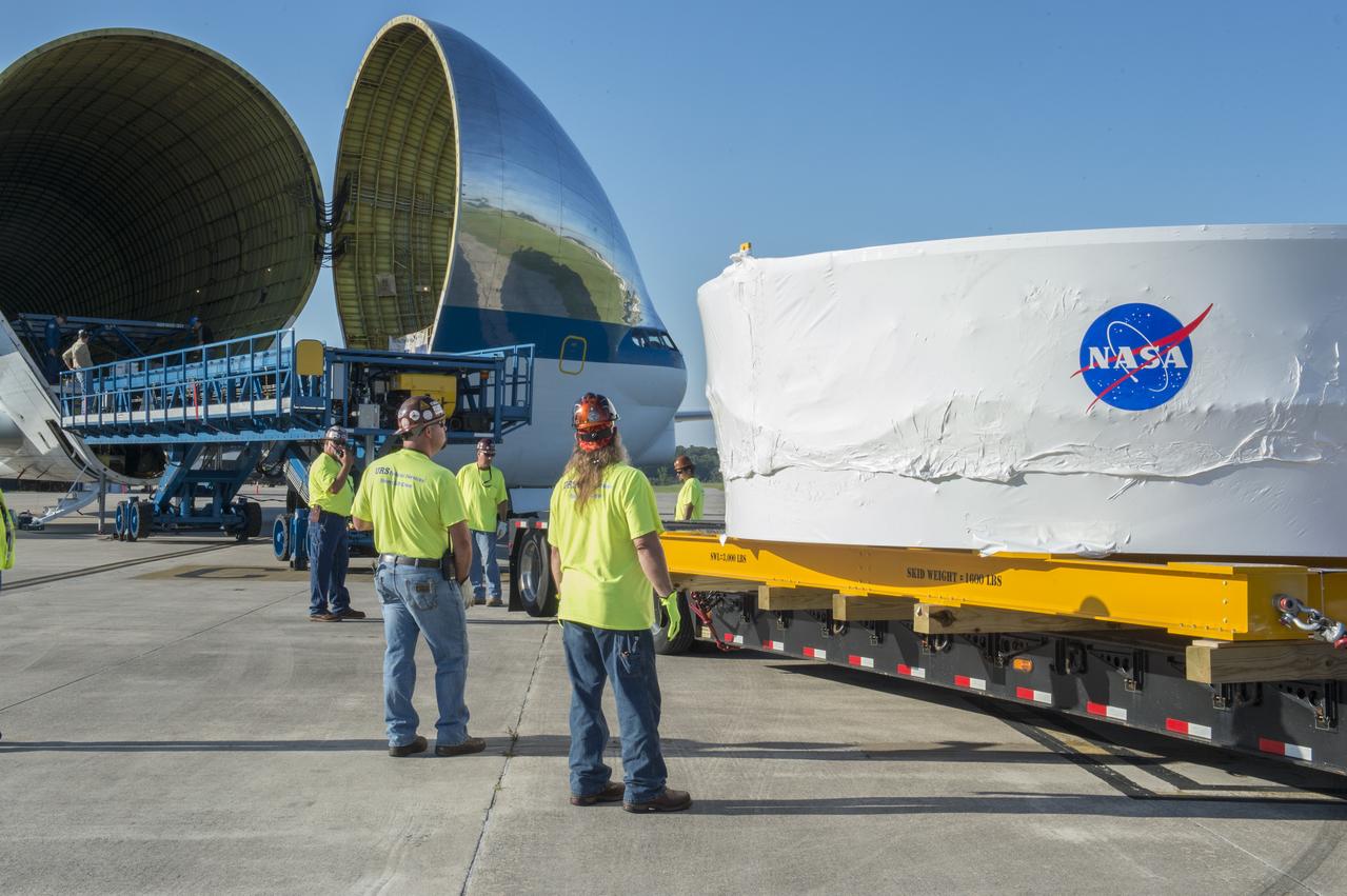 The Orion stage adapter is being positioned for lifting onto the loading platform before being loaded into NASA's Super Guppie aircraft. The adapter will be flown to Denver, Colorado for further testing.