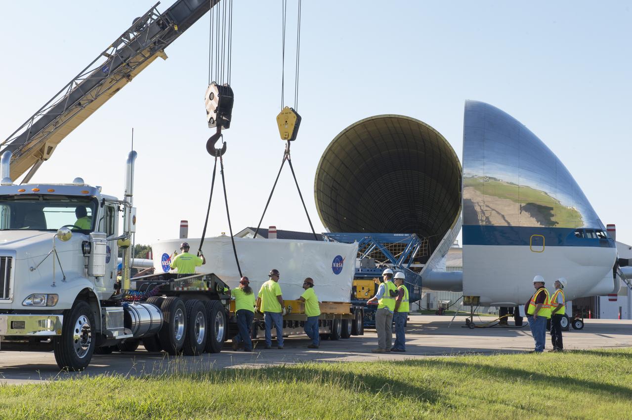 The Orion stage adapter is being positioned for lifting onto the loading platform before being loaded into NASA's Super Guppie aircraft. The adapter will be flown to Denver, Colorado for further testing.