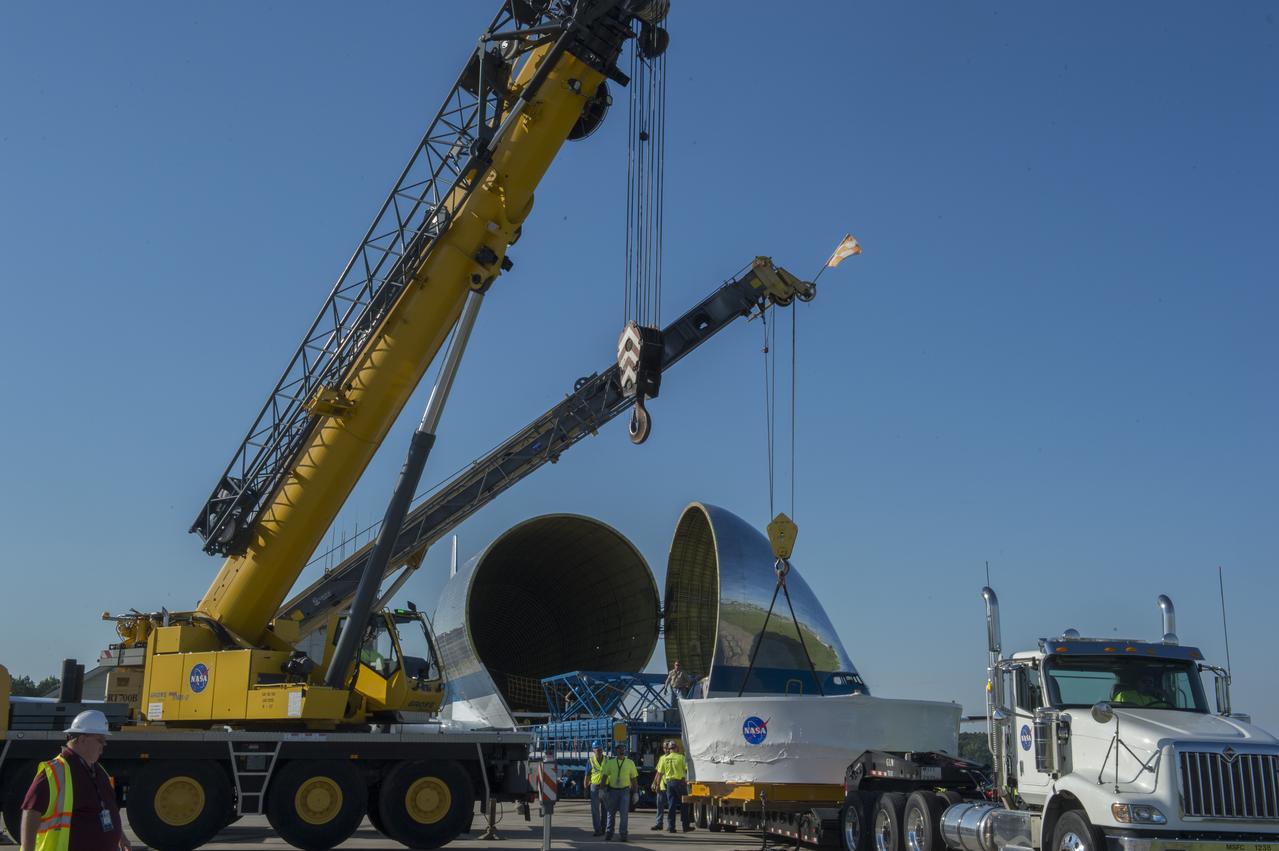 The Orion stage adapter is being positioned for lifting onto the loading platform before being loaded into NASA's Super Guppie aircraft. The adapter will be flown to Denver, Colorado for further testing.