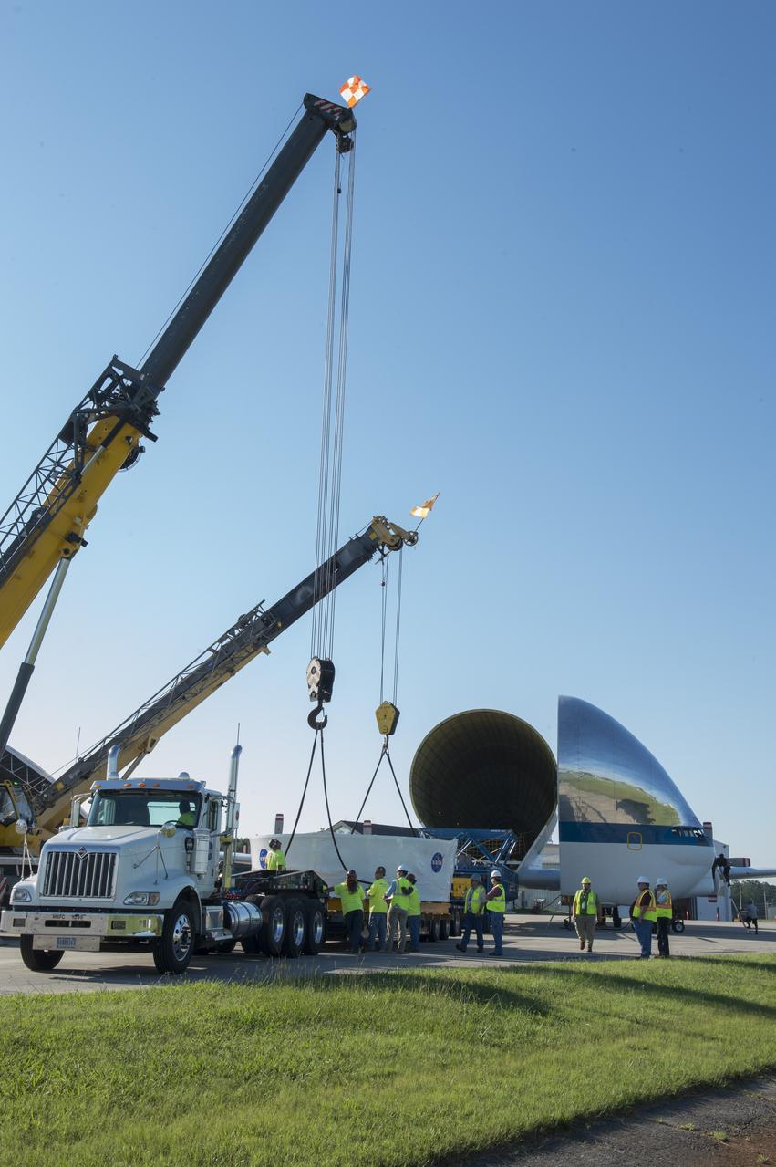 The Orion stage adapter is being positioned for lifting onto the loading platform before being loaded into NASA's Super Guppie aircraft. The adapter will be flown to Denver, Colorado for further testing.