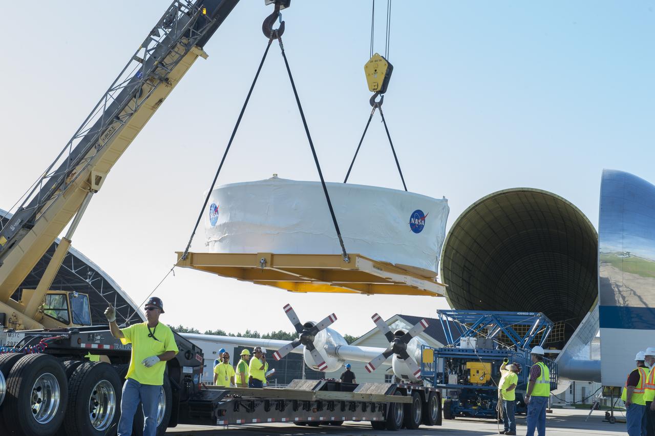 The Orion stage adapter is being lifted for placement onto the loading platform for NASA's Super Guppie aircraft before being flown to Denver, Colorado for further testing.