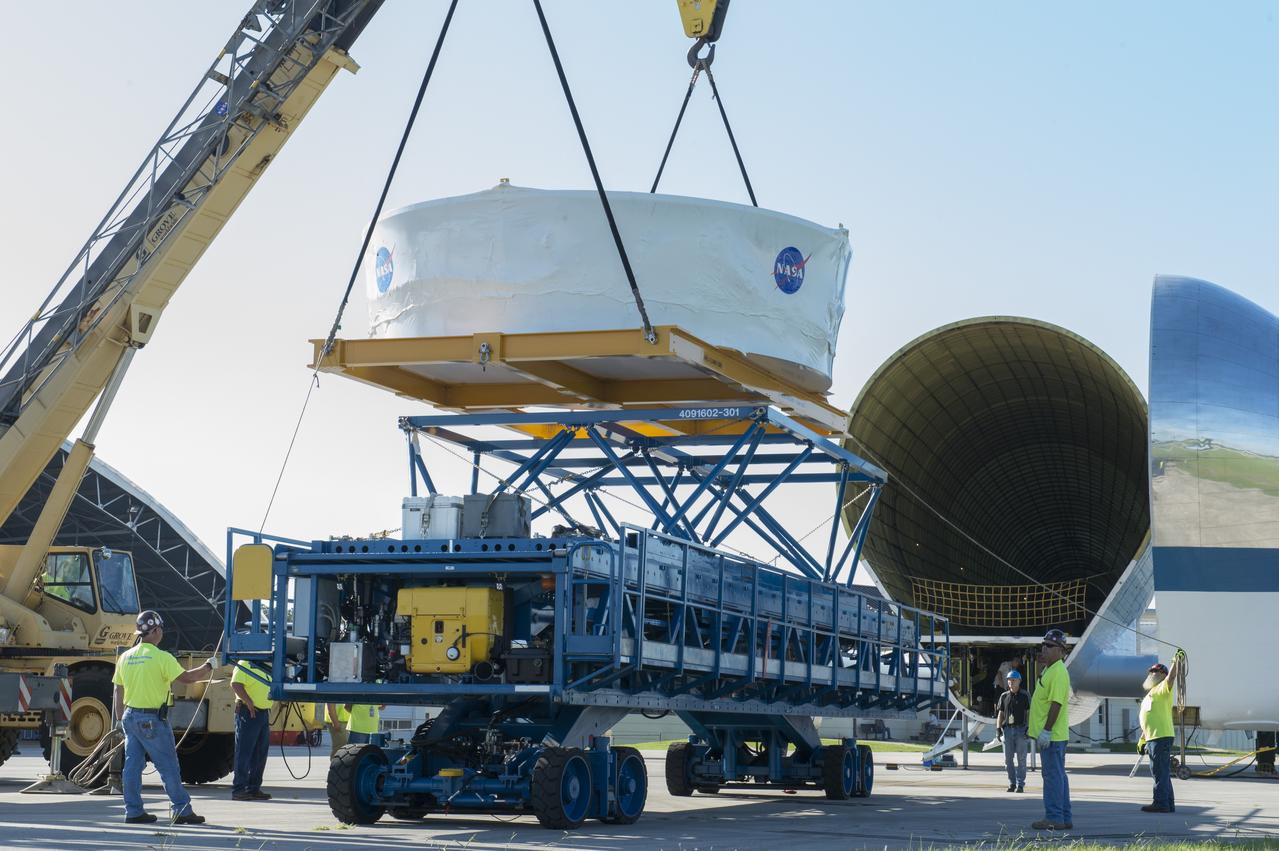 The Orion stage adapter is being lifted for placement onto the loading platform for NASA's Super Guppie aircraft before being flown to Denver, Colorado for further testing.