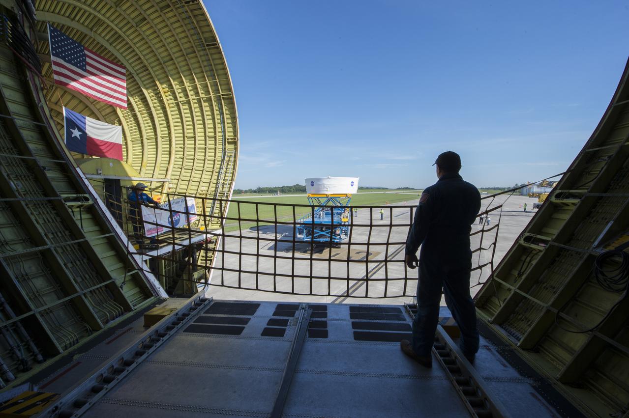 The Orion stage adapter is shown in the background from inside the cargo bay of NASA's Super Guppie. The stage adapter is being flown to Denver, Colorado where it will undergo further testing.