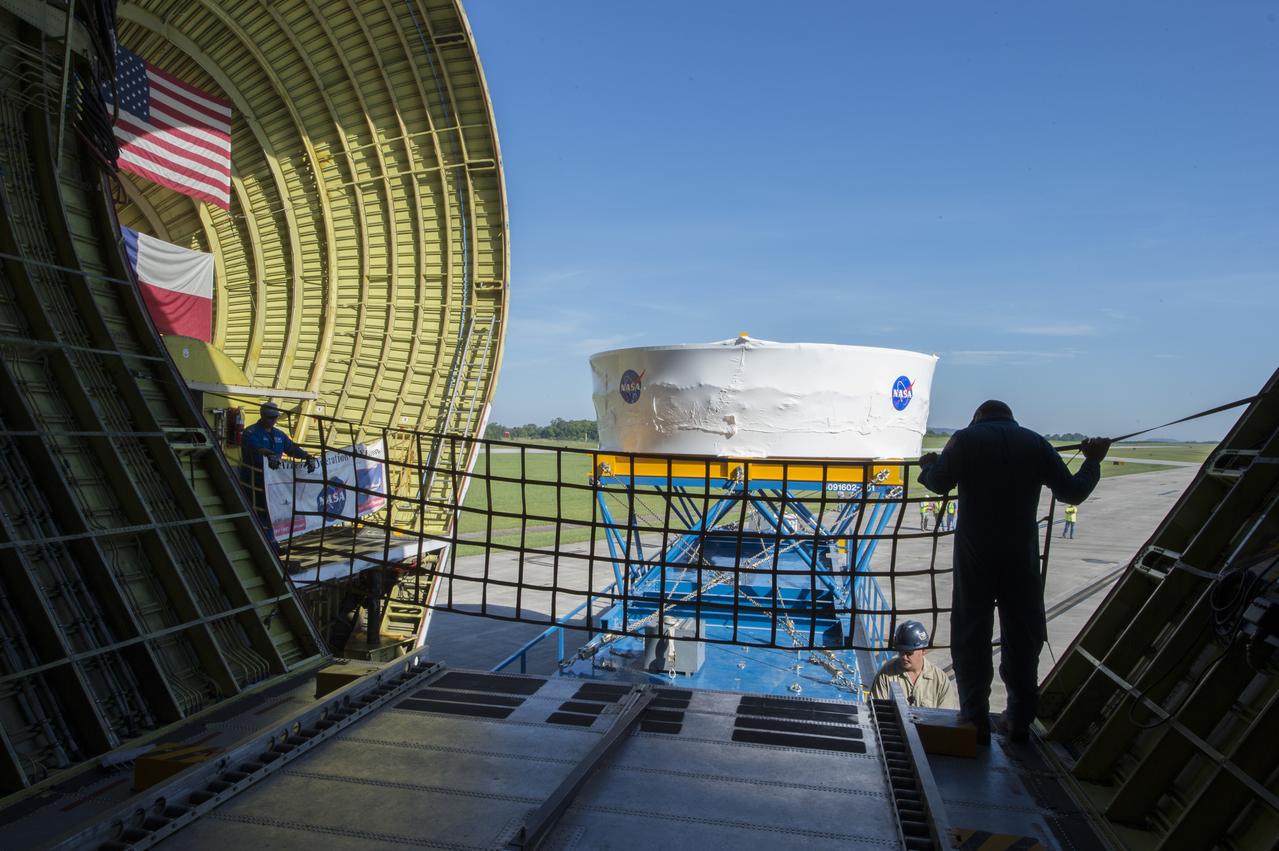 The Orion stage adapter is shown in the background from inside the cargo bay of NASA's Super Guppie. The stage adapter is being flown to Denver, Colorado where it will undergo further testing.