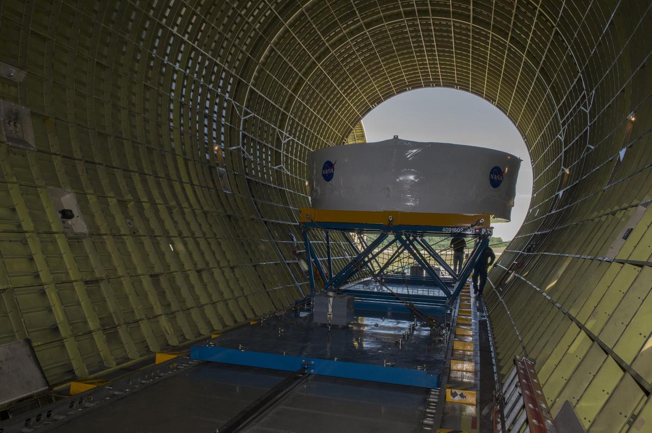 The Orion stage adapter is being placed inside the cargo bay of NASA's Super Guppie aircraft before being flown to Denver, Colorado for further testing.