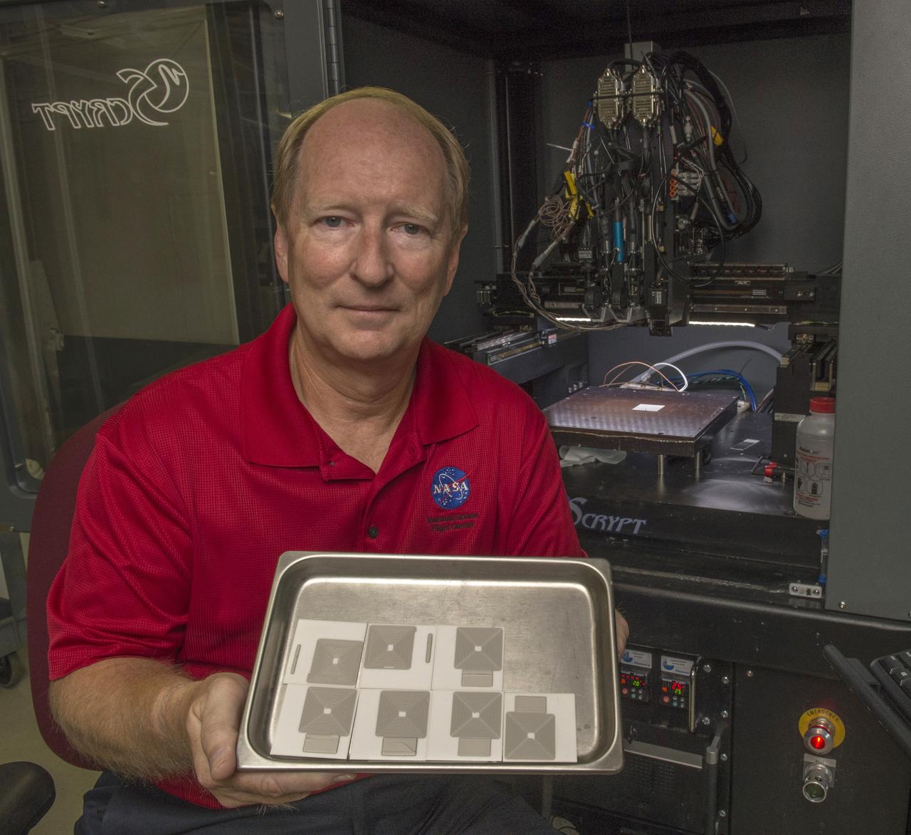Curtis Hill (EM32/ESSSA) shows recently printed silver antenna arrays with Marshall’s nScrypt® Multi-Material Deposition System (background