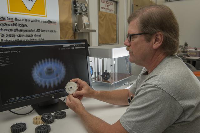 NASA image: Phillip Steele with composite material gears