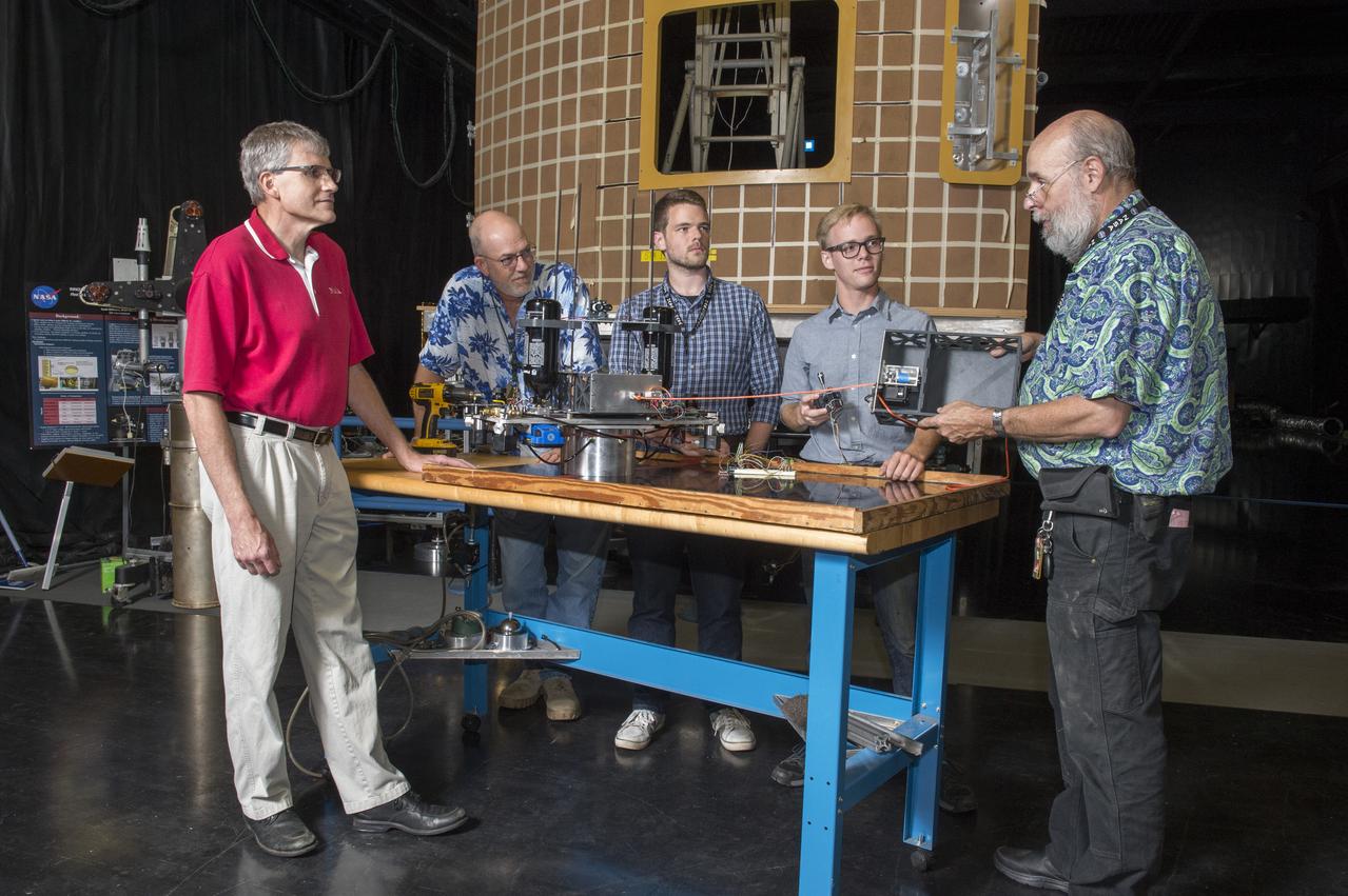 Electric Sail (E-Sail) Tether Team Discusses 6U CubeSat Test Article and Tether Deployment System  (Right to left:  Tom Bryan, Davis Hunter (student intern), Jonathan MacArthur (student intern), Charles Cowen, Mike Tinker)